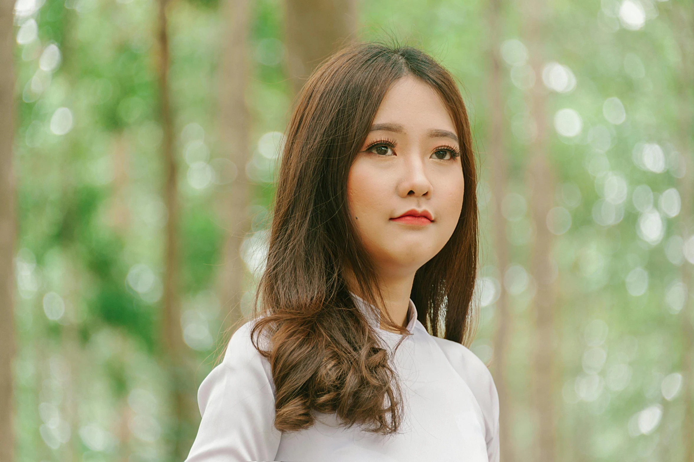 a woman standing in the middle of a forest, inspired by Ruth Jên, pexels contest winner, realism, young cute wan asian face, ao dai, white background, brown medium length hair