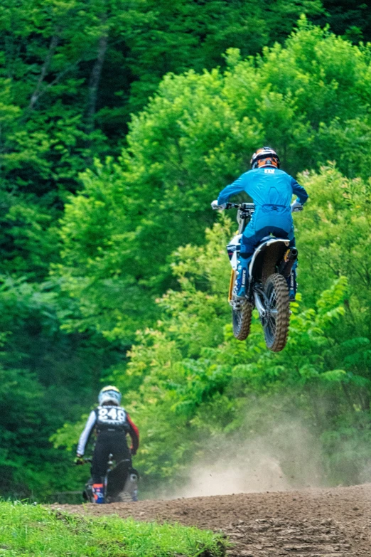 the person is flying through the air on the motorcycle