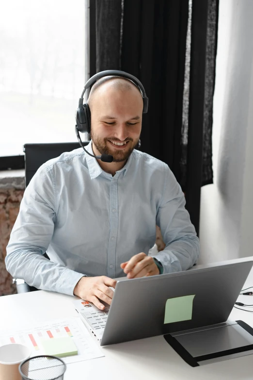 a man sitting at a desk with a laptop and headphones, sitting in front of a microphone, supportive, language, thumbnail