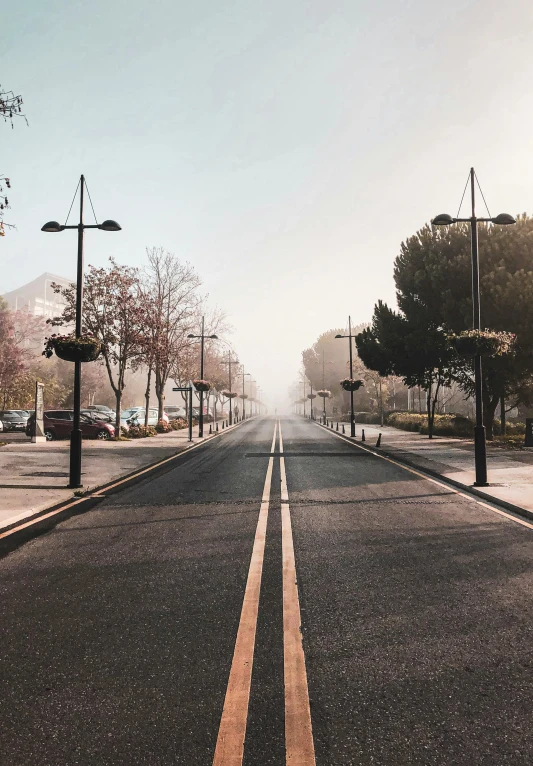 a street with a long yellow line down one end of the road