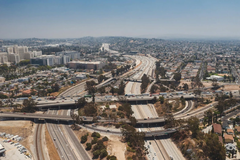 an aerial view of a freeway running through a city, by Josh Bayer, stacked image, mission arts environment, 4k panoramic, grain”