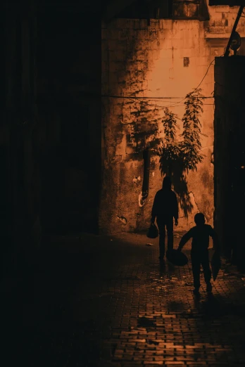 a couple of people walking down a street at night, an album cover, by Ahmed Yacoubi, pexels contest winner, light over boy, moroccan city, dark dirty grungy streets, silhouette