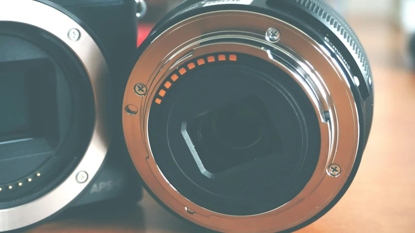 a camera sitting on top of a wooden table, zoomed in shots, aperture gradient, unsplash 4k, high-quality dslr photo”