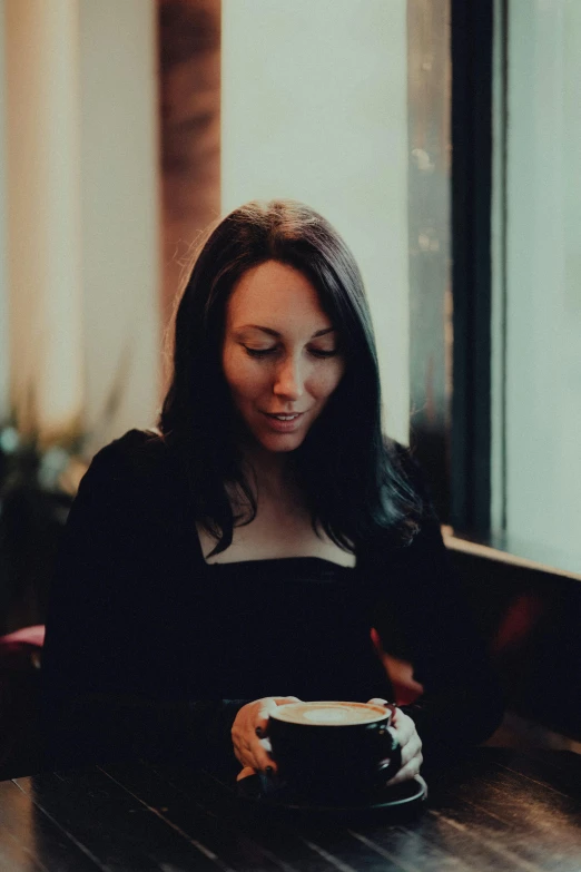 a woman sitting down looking at her cell phone