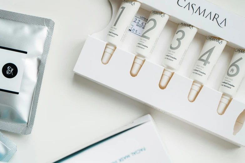 an assortment of skin care products sitting on a table, casiopea, high samples, medium close up, white box