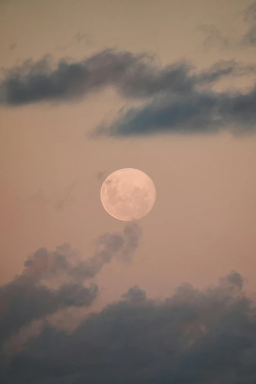 a plane is flying in the sky with the moon overhead