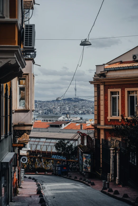 an empty street in the middle of a city, a colorized photo, pexels contest winner, istanbul, city on a hillside, brown, paisley