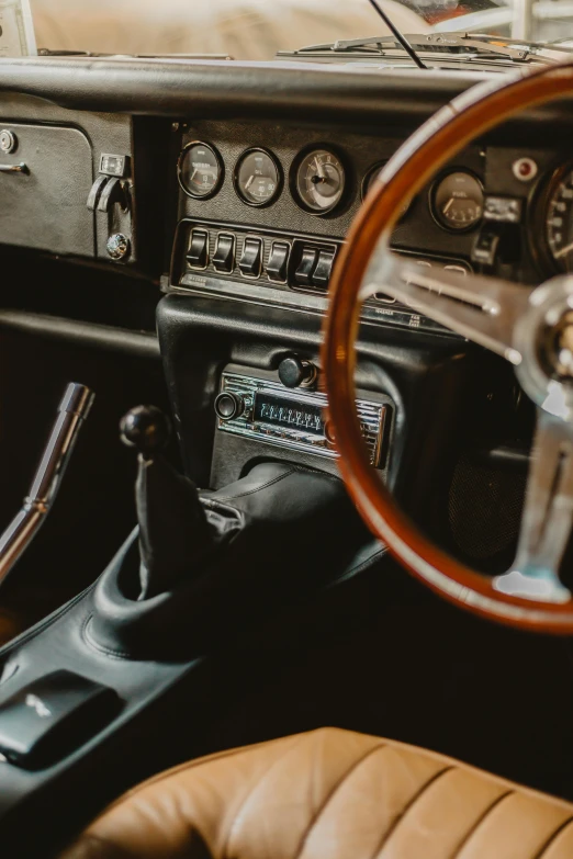 a close up of a steering wheel and dashboard of a car, by Daniel Seghers, trending on unsplash, ( ( ( ( ( jaguar e - type car, rectangle, 15081959 21121991 01012000 4k, natural soft light