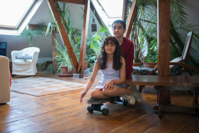 a man and woman sitting on the ground with skateboards