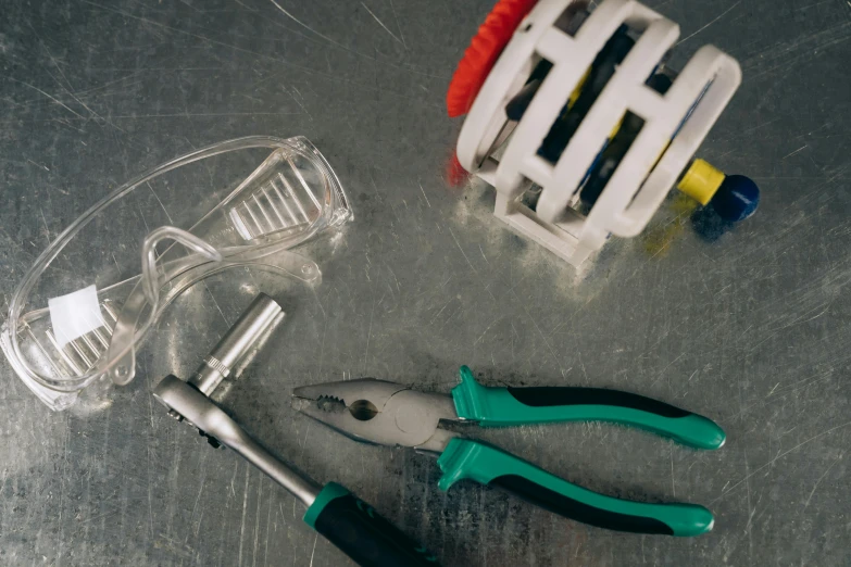 a couple of pliers sitting on top of a table, a still life, pexels, plasticien, bio mechanical, worksafe. instagram photo, circular, full shot ( fs )