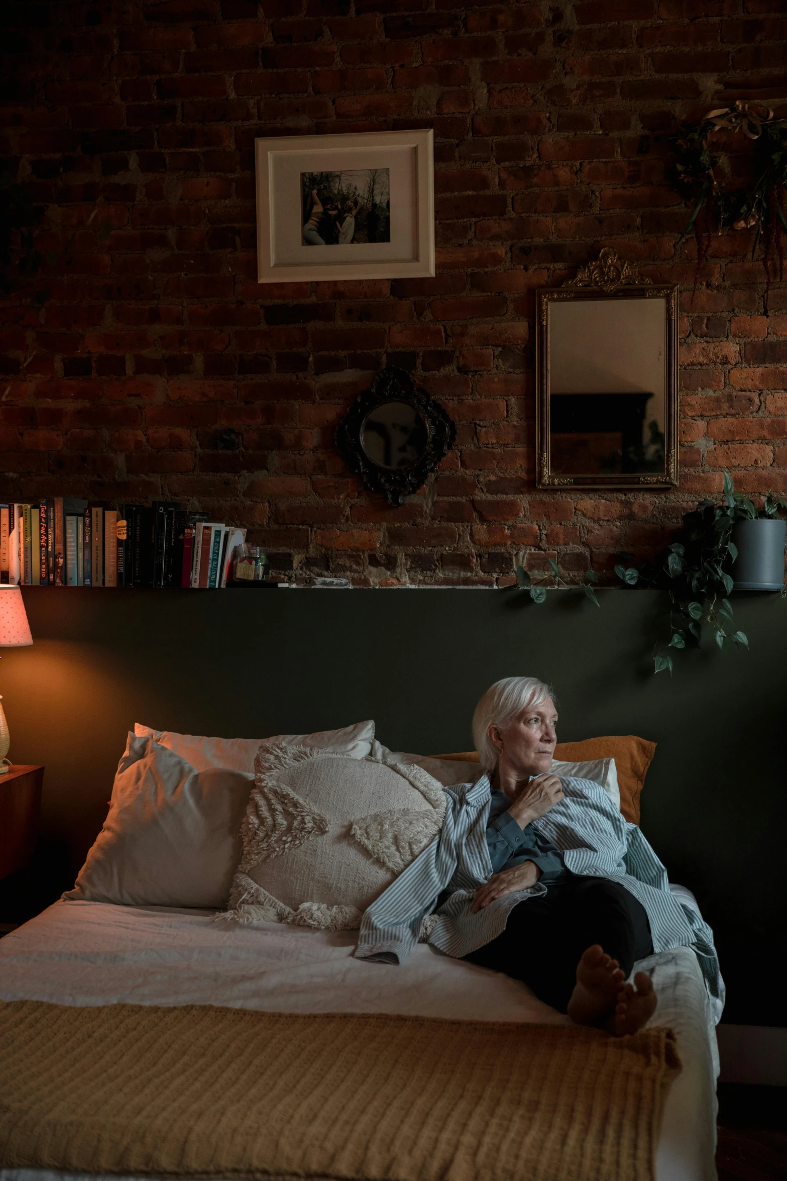 a woman resting in bed with her head up