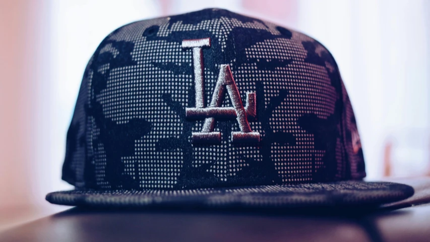 a baseball cap sitting on top of a table, a picture, inspired by L. A. Ring, unsplash, digital camo, lattice, !dream los angeles, hd wallpaper