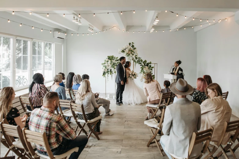 the wedding couple is at their ceremony in the middle of a group