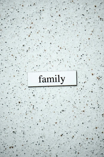 a white sign with the word family on it, an album cover, unsplash, granite, magnetic, label, multiple stories
