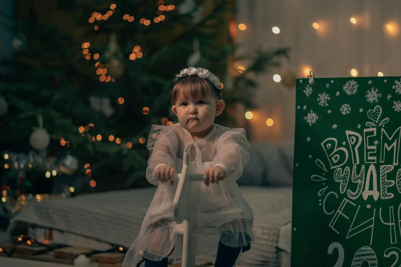 the little girl is playing on her skateboard near a sign