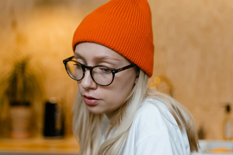 a close up of a person wearing a hat and glasses, by Julia Pishtar, trending on pexels, orange head, beanie, without makeup, alexey gurylev