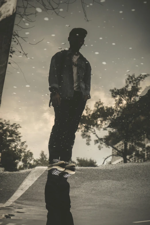 a man riding a skateboard across a puddle of water, inspired by casey baugh, pexels contest winner, full body:: snow outside::, ( ( dark skin ) ), standing on a hill, thoughtful