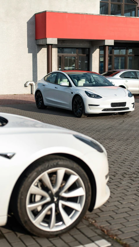 the back end of two parked cars next to each other