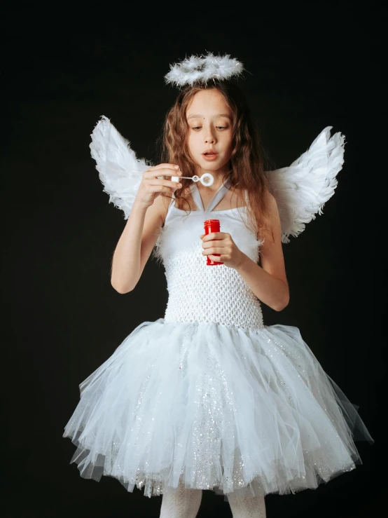 a little girl dressed as an angel blowing bubbles, inspired by Marie Angel, pexels contest winner, holding ego weapons, teen elf, gif, high quality theatre costume