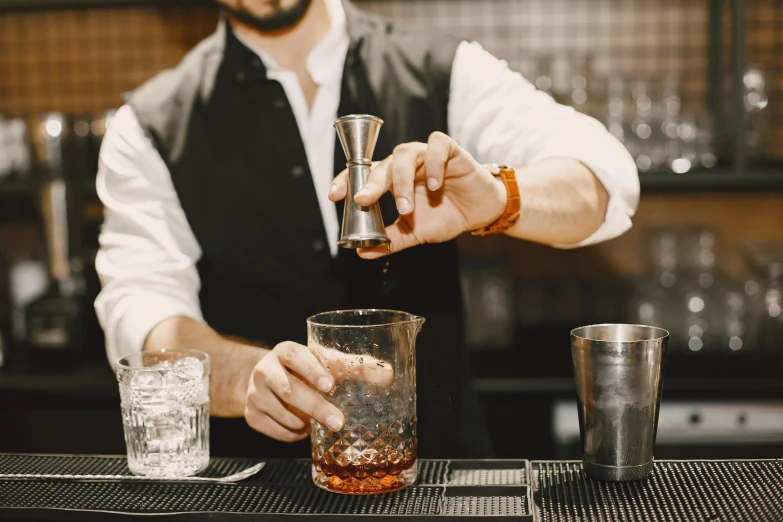 a man is making a drink at a bar, trending on pexels, renaissance, beakers, aussie baristas, thumbnail, zoomed in