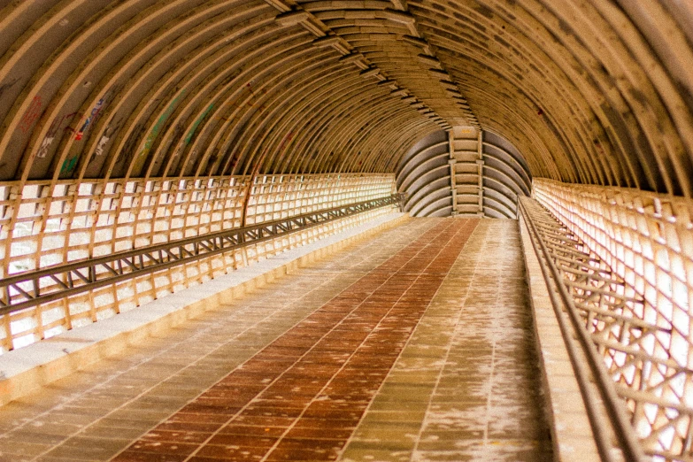 a train that is sitting inside of a tunnel, by Christo, unsplash, visual art, inside a farm barn, catwalk, beige, detiled