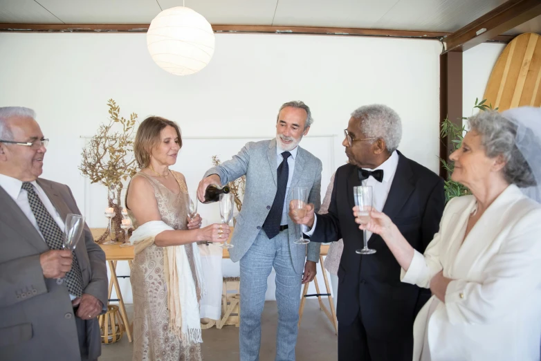 a group of people standing next to each other holding wine glasses, silver，ivory, linen, middle shot, engaging