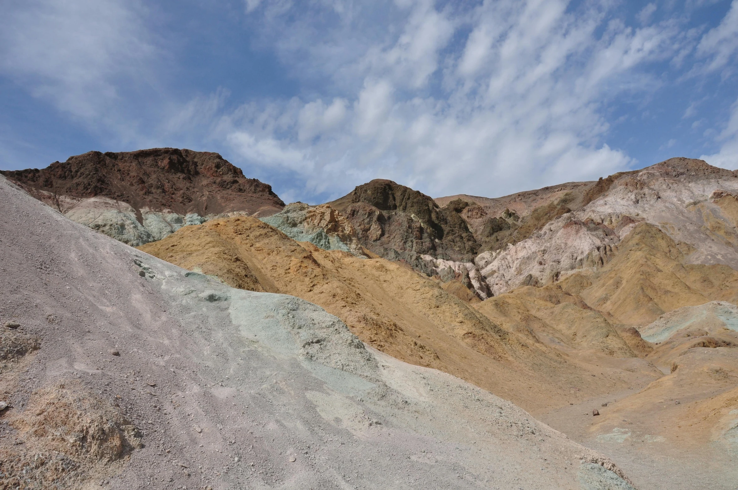 a view of mountains that are in the middle of the desert