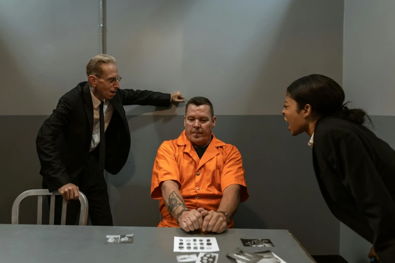 a couple of people that are sitting at a table, prison scene, meet the actor behind the scenes, till lindemann, gettyimages