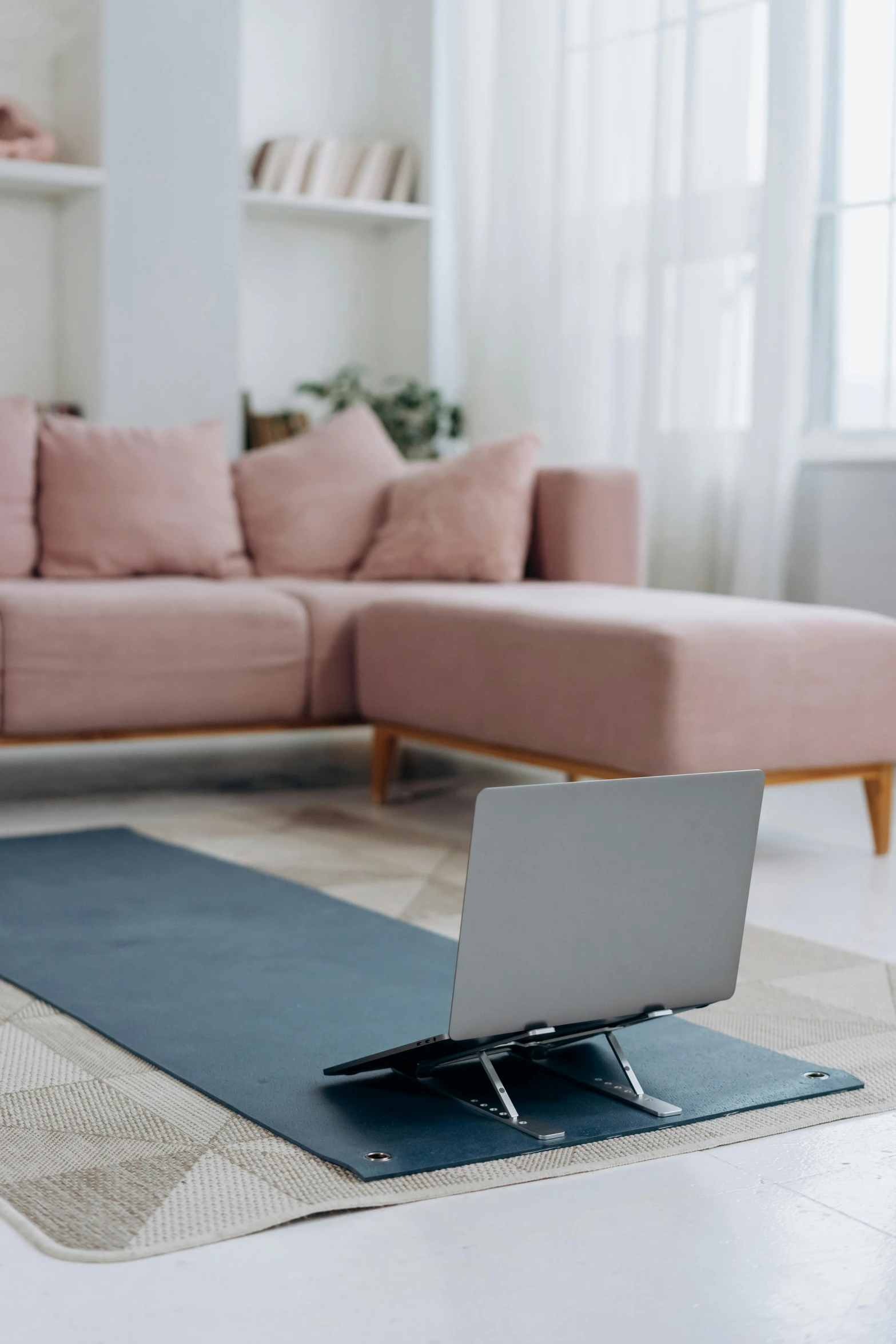 a yoga mat with a laptop on top of it, light and space, lounge furniture, angle, my home, large open room