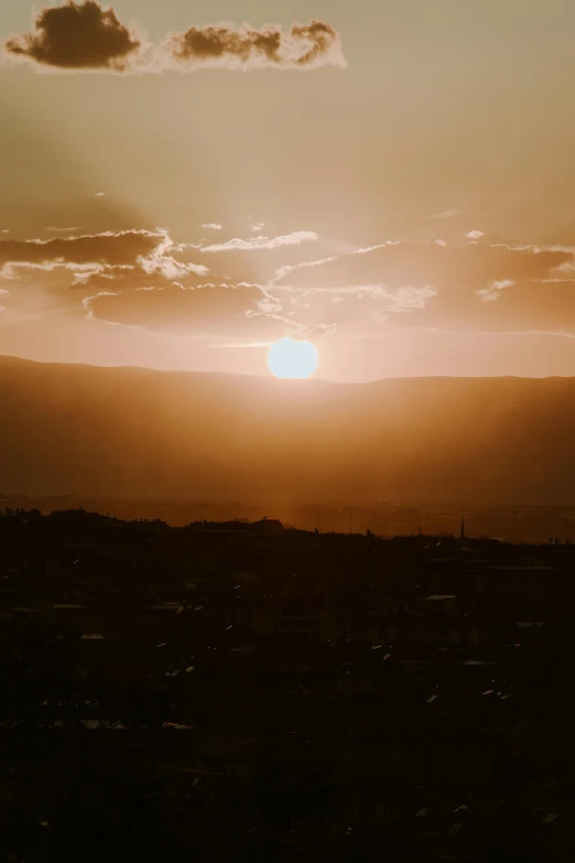 a person is flying a kite at sunset, by Alexis Grimou, pexels contest winner, distant town in valley and hills, an expansive view of the sun, two suns, today\'s featured photograph 4k