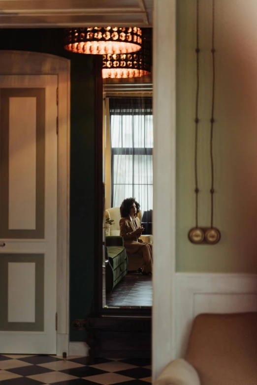 woman sitting on couch in hallway near large window