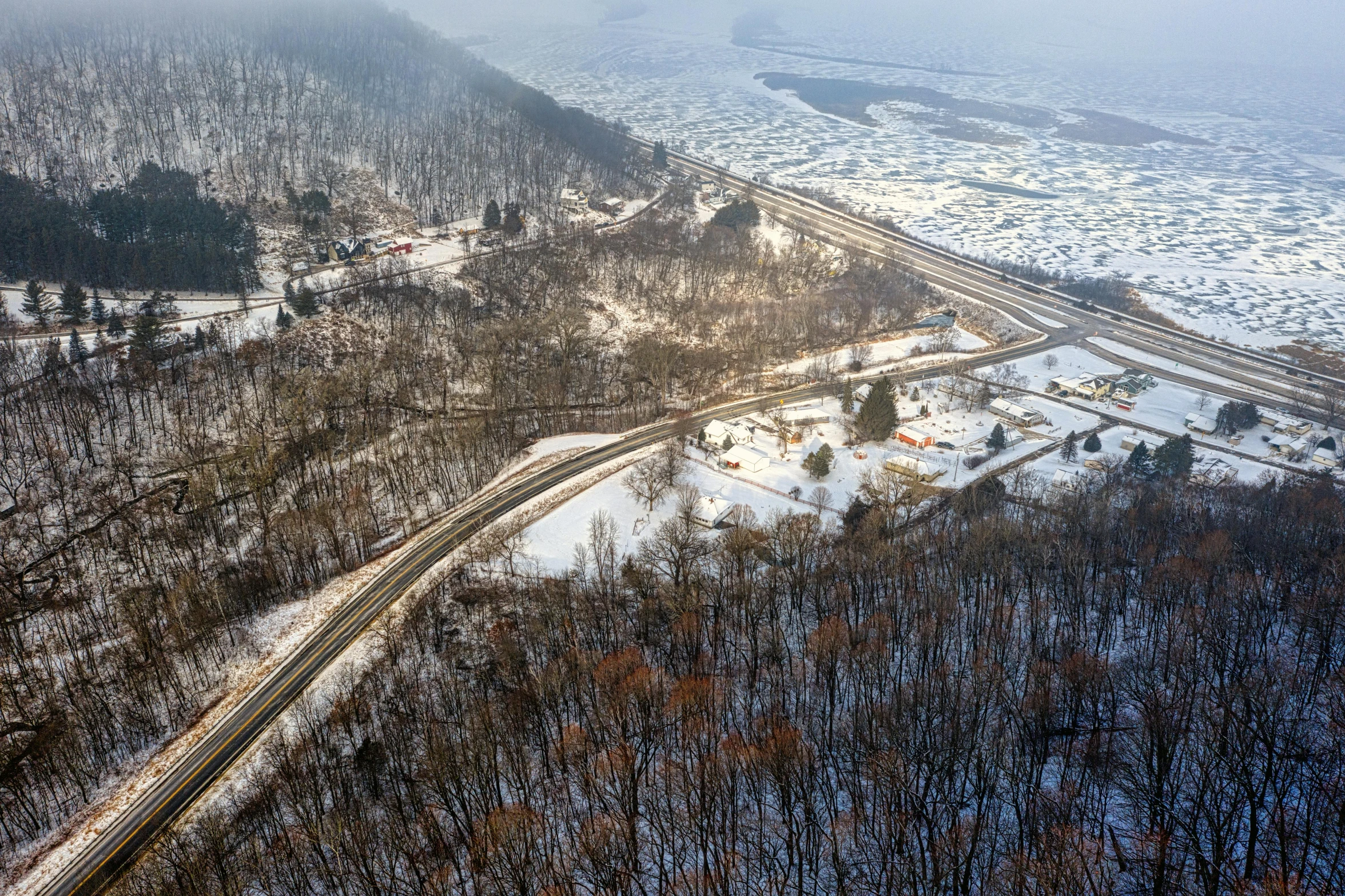 a train traveling through a rural countryside covered in snow, by Jang Seung-eop, pexels contest winner, aerial view of an ancient land, joongwon jeong, william penn state forest, thumbnail