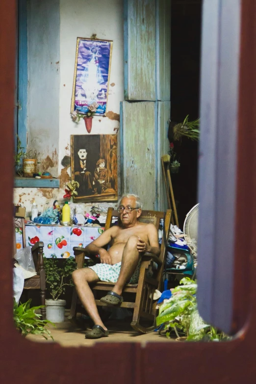 a man is sitting in his chair with food in the living room