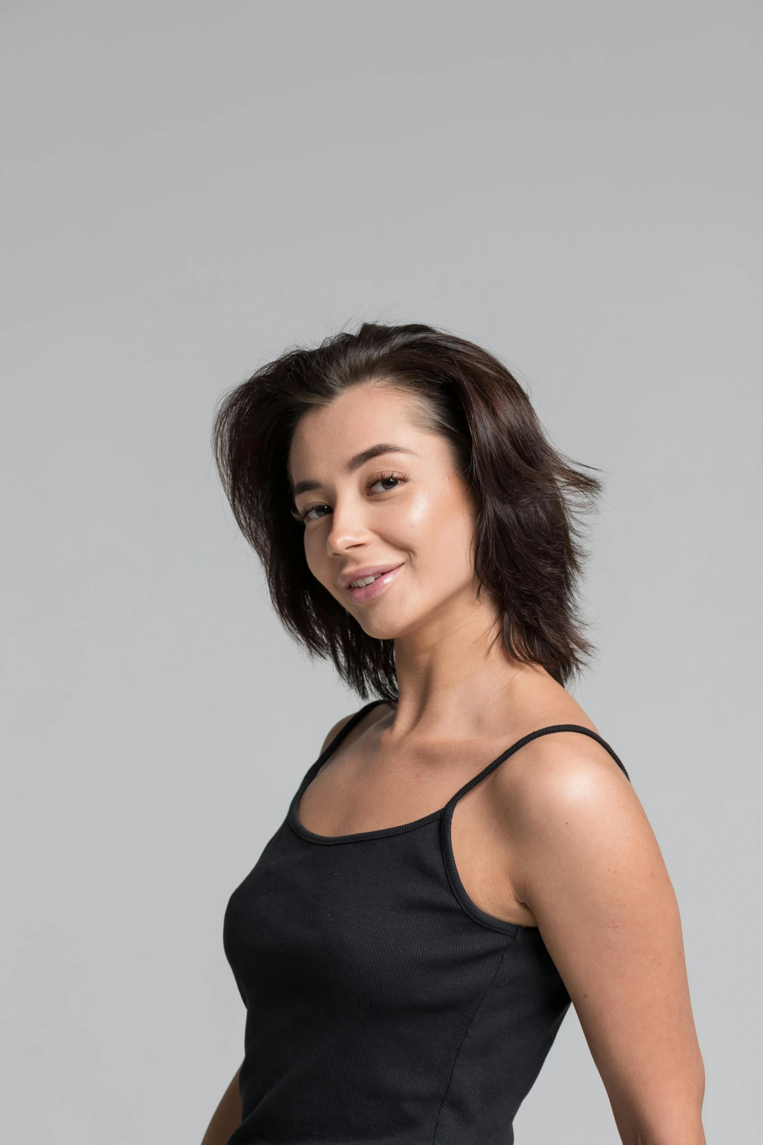 a woman in a black dress posing for a picture, she is wearing a black tank top, windblown dark hair, artem chebokha, avatar image