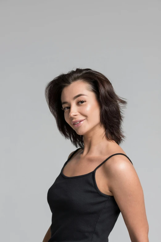 a woman in a black dress posing for a picture, she is wearing a black tank top, windblown dark hair, artem chebokha, avatar image