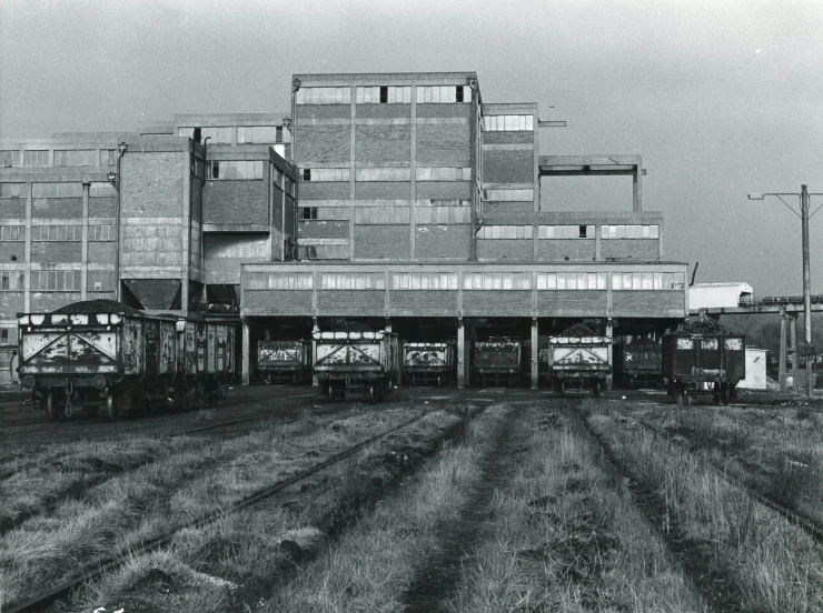 a black and white photo of a train yard, brutalism, colour photo, mill, osr, full building