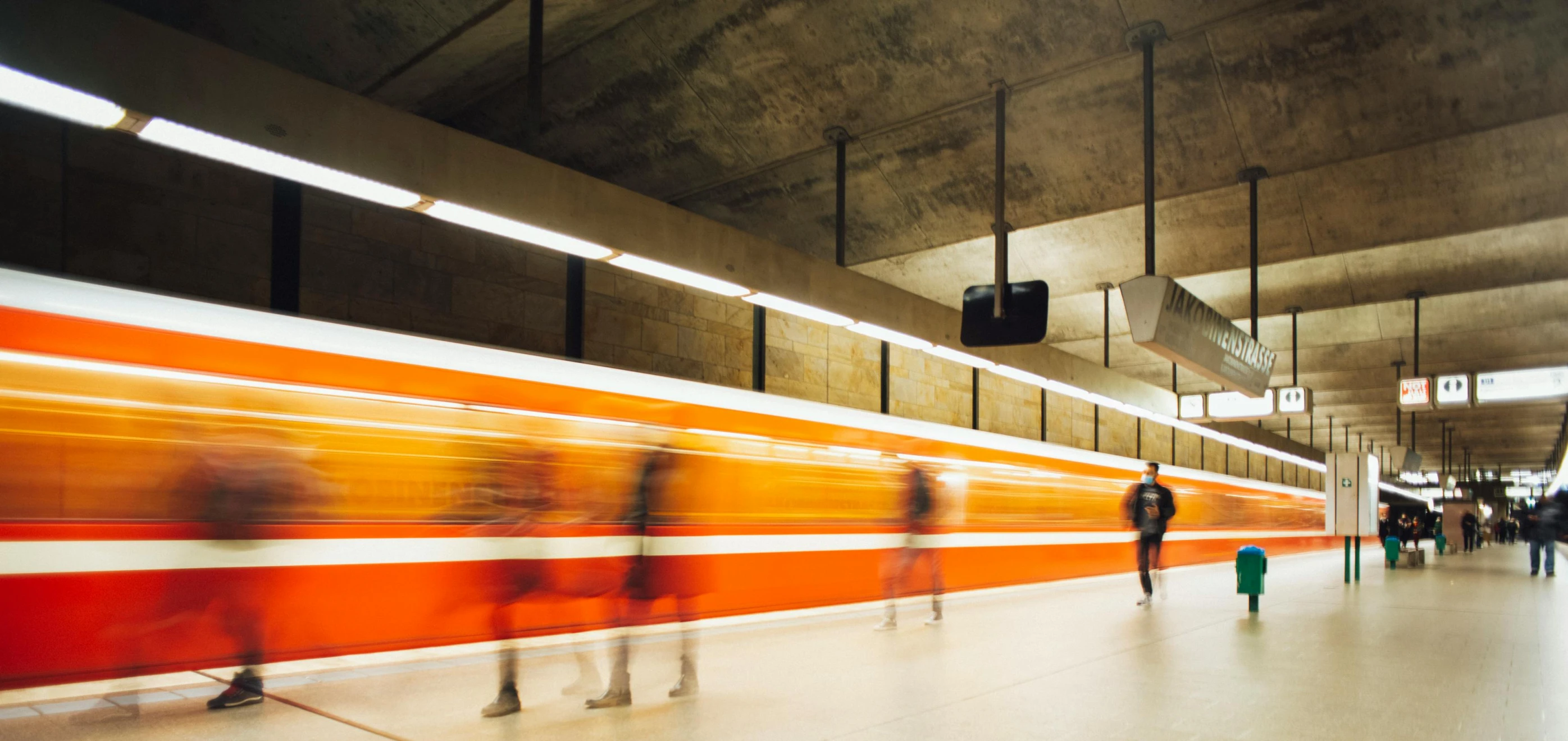 a group of people walking through a train station, pexels contest winner, figuration libre, orange line, spanish, underground art, realistic »