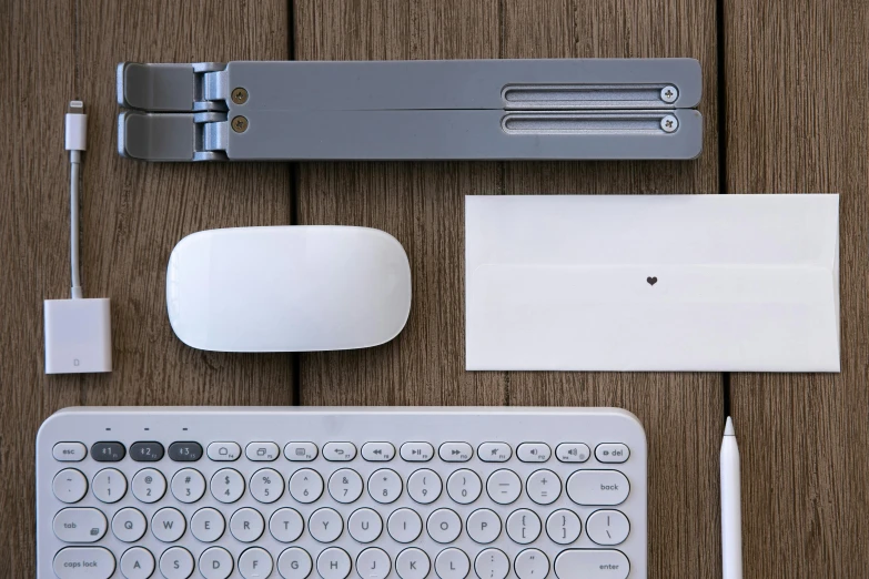 a keyboard and mouse sitting on top of a wooden table, various items, thumbnail, grey, assembled