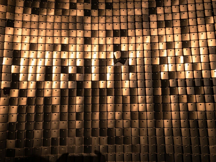 a person standing in front of a metal wall, a mosaic, by Jan Rustem, unsplash, kinetic art, sconces, cardboard, detail texture, light coming from above
