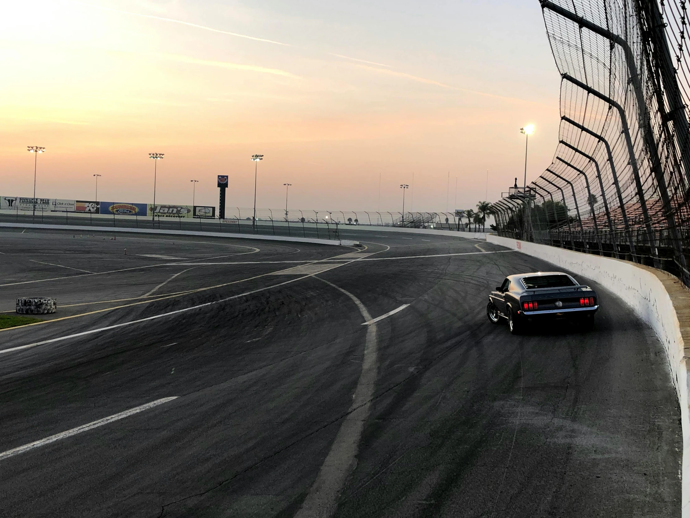 a car is driving down the road on a nice day