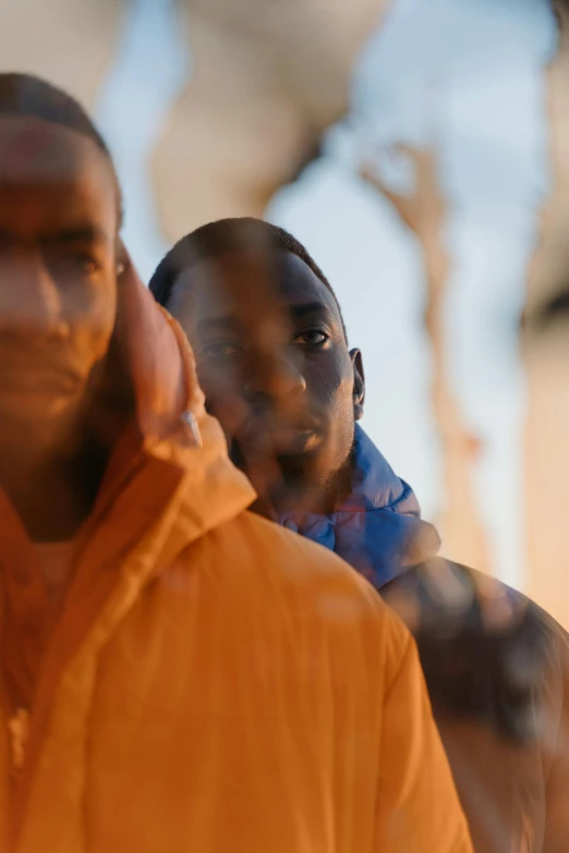 a man walking down the street next to another man