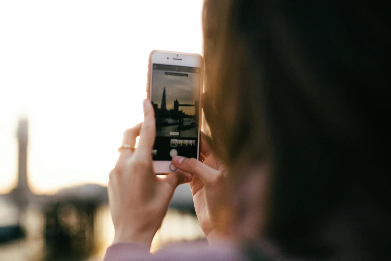 a woman taking a picture of the eiffel tower, a picture, trending on unsplash, happening, girl making a phone call, golden hour closeup photo, the photo was taken from a boat, everything fits on the screen