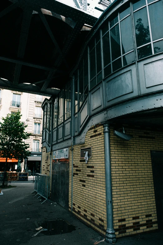a man riding a skateboard up the side of a building, an album cover, unsplash, paris school, monorail station, under repairs, steel archways, seen from outside