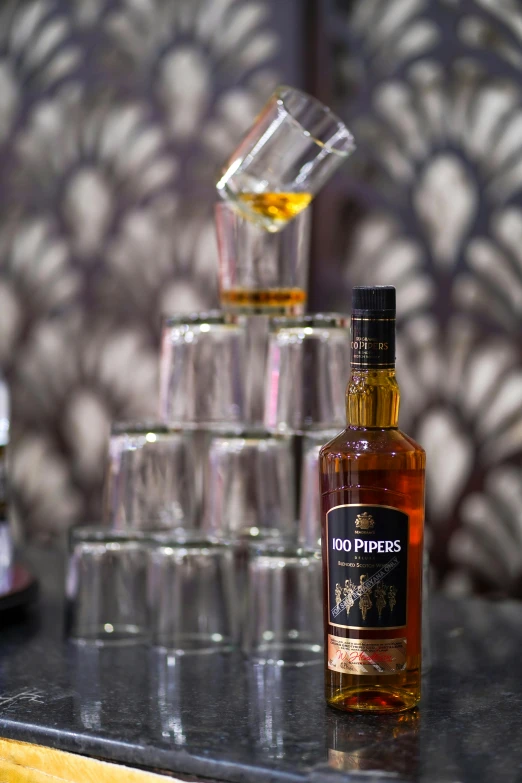 a bottle of liquor sitting on top of a counter, golden towers, on display, rum, thumbnail