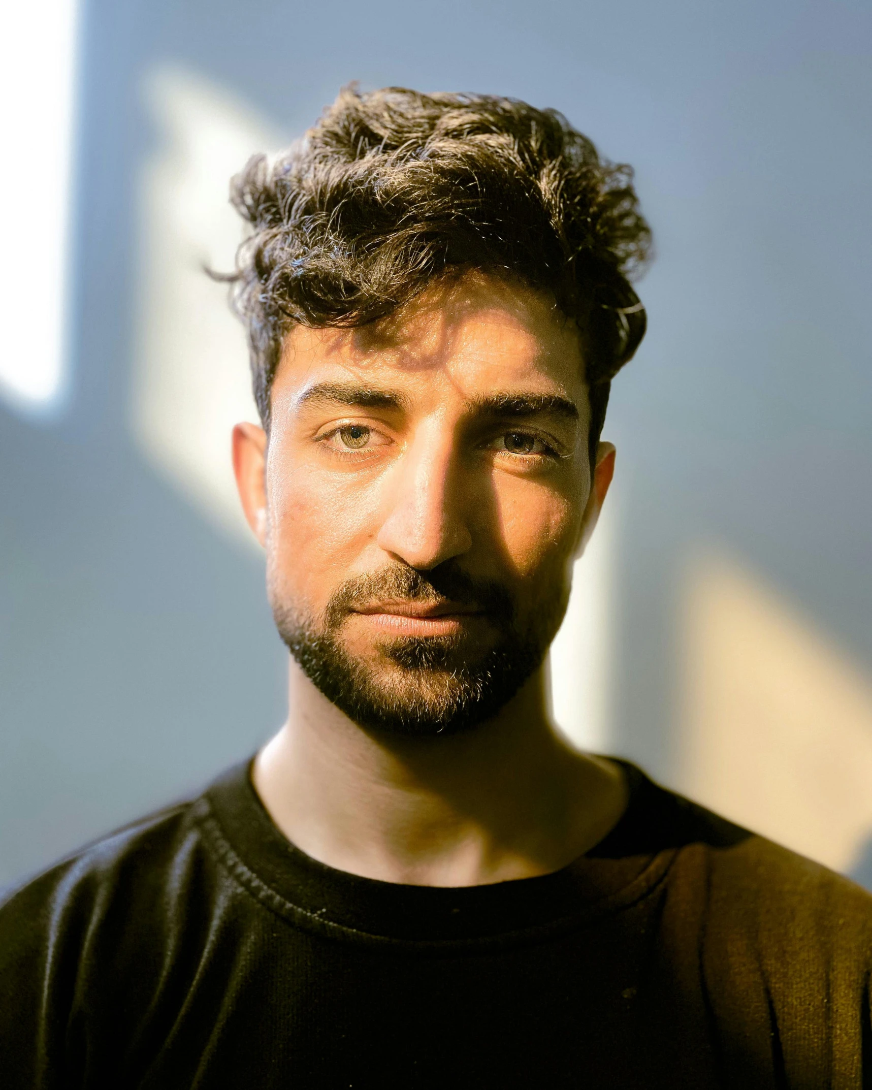 a man standing in the light with a black t - shirt