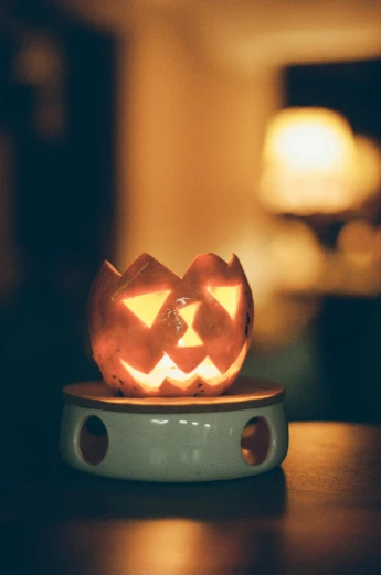 a small jack o lantern lit up with halloween lights