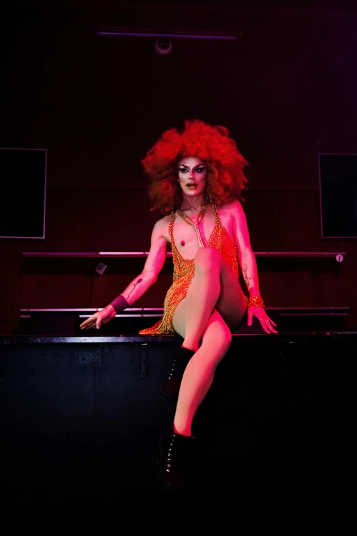 a woman sitting on top of a table