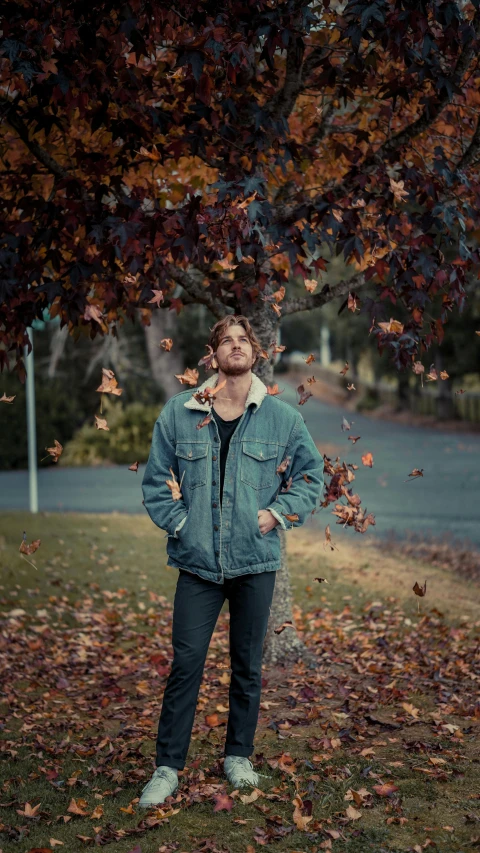 a man with one leg on his chest under a tree