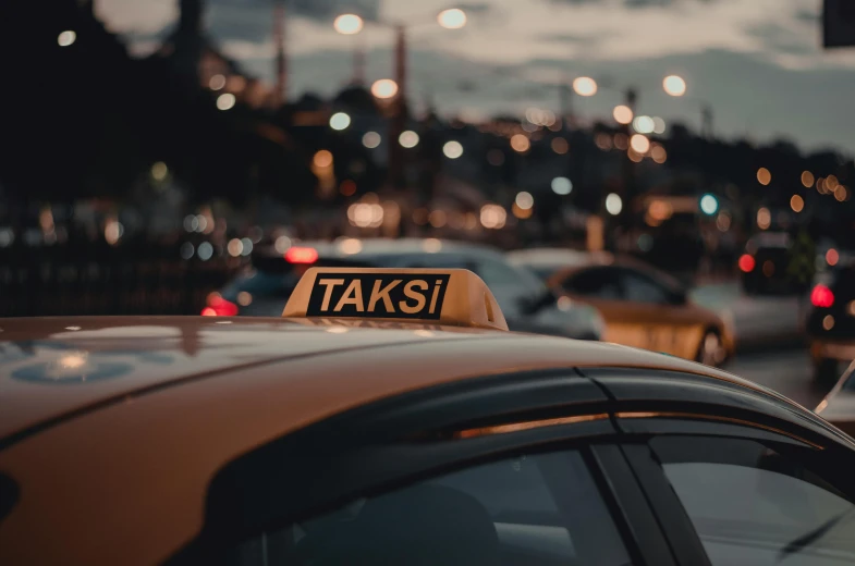 taxis sit parked on the street at dusk