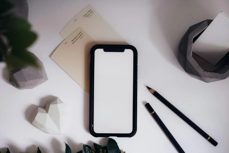 a phone sitting on top of a table next to a plant, a picture, trending on pexels, black ball pen on white paper, background image, product introduction photo, clean black outlines